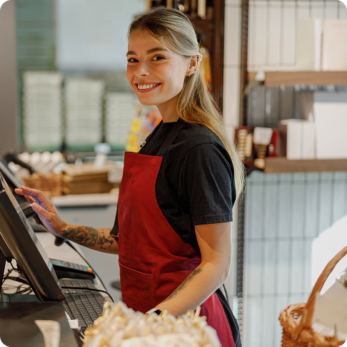 smiling-barista-cafe-counter-engaging-with-customers-using-modern-register 1